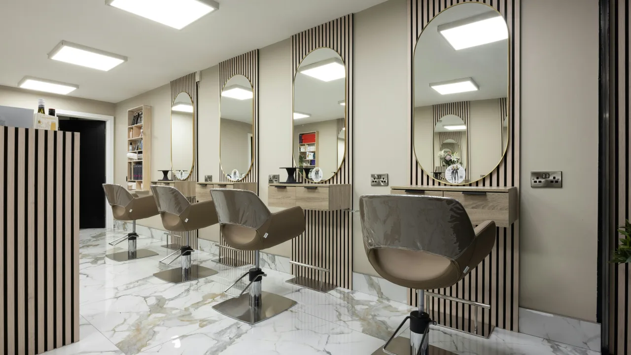 Bright beauty salon interior with arched mirrors and styling chairs