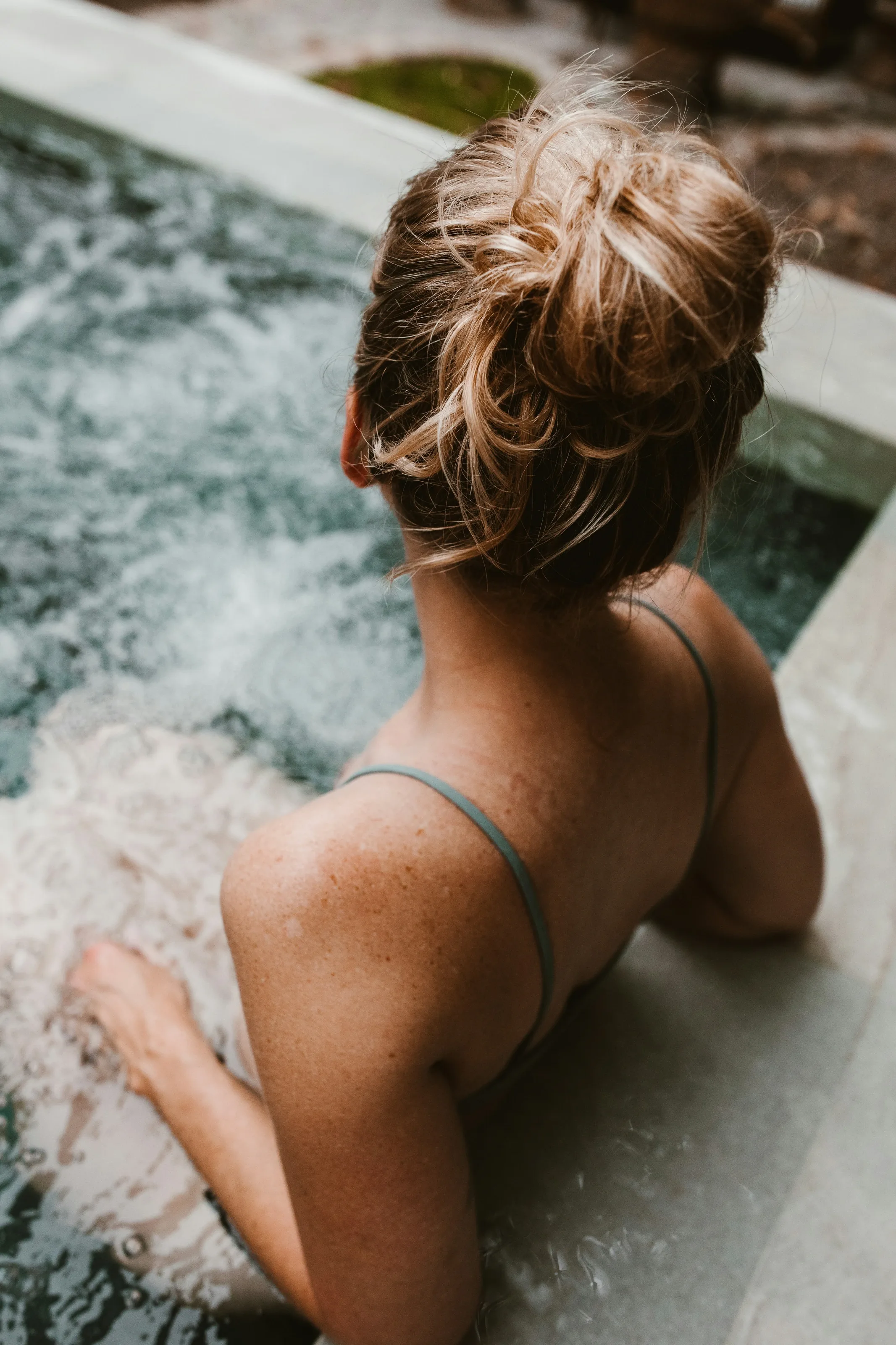 Woman relaxing in a warm spa bath
